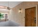 Inviting entrance featuring a wood door and a textured wall at 3031 N Civic Center Plz # 317, Scottsdale, AZ 85251