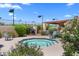 Community hot tub, surrounded by lush landscaping with a barbecue grill and chairs at 3031 N Civic Center Plz # 317, Scottsdale, AZ 85251