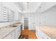 Bright kitchen offers stainless appliances, granite counters, white cabinets, and wood floors at 3031 N Civic Center Plz # 317, Scottsdale, AZ 85251
