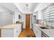 Kitchen features modern appliances, granite counters, white cabinets and wood flooring at 3031 N Civic Center Plz # 317, Scottsdale, AZ 85251