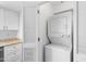 Laundry room with washer/dryer, white cabinets and granite countertops at 3031 N Civic Center Plz # 317, Scottsdale, AZ 85251
