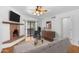 Bright living room features a brick fireplace, ceiling fan, and sliding doors to the outdoor patio at 3031 N Civic Center Plz # 317, Scottsdale, AZ 85251