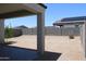 View from covered patio showcasing desert landscaped yard, privacy block wall and solar panels on house in distance at 30918 W Mulberry W Dr, Buckeye, AZ 85396