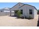 Expansive backyard with desert landscaping, featuring a covered patio that creates a comfortable outdoor living space at 30918 W Mulberry W Dr, Buckeye, AZ 85396