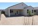 Spacious backyard with a covered patio, complemented by drought-resistant desert landscaping at 30918 W Mulberry W Dr, Buckeye, AZ 85396