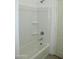 Bright bathroom showcasing a shower-tub combo with built-in shelves at 30918 W Mulberry W Dr, Buckeye, AZ 85396