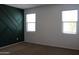 Bedroom featuring two windows with blinds and geometric wall paneling at 30918 W Mulberry W Dr, Buckeye, AZ 85396