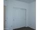 Bedroom featuring a closet with sliding doors, neutral carpet, and freshly painted white walls at 30918 W Mulberry W Dr, Buckeye, AZ 85396