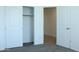 Bedroom featuring a spacious closet with bi-fold doors and adjacent doorway to another room at 30918 W Mulberry W Dr, Buckeye, AZ 85396