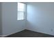 Bright bedroom showcasing a large window for natural light, neutral carpet, and freshly painted white walls at 30918 W Mulberry W Dr, Buckeye, AZ 85396