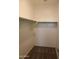 Walk-in closet with neutral walls, shelving and a carpeted floor at 30918 W Mulberry W Dr, Buckeye, AZ 85396