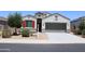 Charming single-story home with manicured landscaping, a two-car garage, and a well-maintained lawn at 30918 W Mulberry W Dr, Buckeye, AZ 85396
