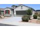 Well-maintained home with a two-car garage, gravel landscaping, and a neutral exterior at 30918 W Mulberry W Dr, Buckeye, AZ 85396