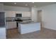 Open concept kitchen with white cabinetry, granite countertops, and stainless appliances at 30918 W Mulberry W Dr, Buckeye, AZ 85396