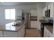 Modern open kitchen with island, granite countertops, and stainless steel appliances at 30918 W Mulberry W Dr, Buckeye, AZ 85396