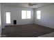 Spacious living room filled with natural light from the windows and back door at 30918 W Mulberry W Dr, Buckeye, AZ 85396