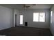 Comfortable carpeted living room with a ceiling fan and a back door at 30918 W Mulberry W Dr, Buckeye, AZ 85396