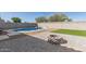 Outdoor living space featuring a swimming pool, fire pit and artificial turf, perfect for entertainment at 3113 N 303Rd Dr, Buckeye, AZ 85396