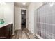 Bathroom with wood-look flooring, neutral walls and vanity and access to a walk-in closet at 3113 N 303Rd Dr, Buckeye, AZ 85396