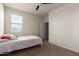 Bright bedroom with neutral walls, ceiling fan, carpet and natural light from a window at 3113 N 303Rd Dr, Buckeye, AZ 85396