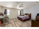Bedroom with wood-look floors, ceiling fan, and lots of natural light at 3113 N 303Rd Dr, Buckeye, AZ 85396