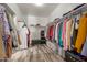 Spacious walk-in closet with wood-look flooring, shelving, and ample space for storage at 3113 N 303Rd Dr, Buckeye, AZ 85396