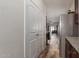 Hallway view shows the continuation of the wood-look floors and the open concept of the home at 3113 N 303Rd Dr, Buckeye, AZ 85396