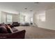 Spacious living room with carpet floors, ceiling fan, and lots of light at 3113 N 303Rd Dr, Buckeye, AZ 85396