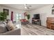Bright living room featuring modern furnishings, wood-look floors, and access to the outdoor space at 3113 N 303Rd Dr, Buckeye, AZ 85396