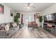 Cozy living room with neutral color palette, ceiling fan, and sliding glass doors to the backyard at 3113 N 303Rd Dr, Buckeye, AZ 85396