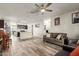Open concept living space with wood-look floors connecting the living room and modern kitchen at 3113 N 303Rd Dr, Buckeye, AZ 85396