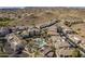 Scenic aerial view of a community featuring a pool, palm trees, and desert landscaping at 3236 E Chandler Blvd # 2003, Phoenix, AZ 85048