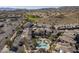 Scenic aerial view of a community featuring a pool, palm trees, and desert landscaping at 3236 E Chandler Blvd # 2003, Phoenix, AZ 85048