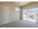 A bright bedroom with a ceiling fan and slider to a private walled patio at 3236 E Chandler Blvd # 2003, Phoenix, AZ 85048