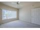 Inviting bedroom featuring neutral walls, a ceiling fan, and plenty of natural light from a large window at 3236 E Chandler Blvd # 2003, Phoenix, AZ 85048