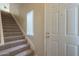 Welcoming entryway featuring a carpeted staircase and bright white door with modern hardware at 3236 E Chandler Blvd # 2003, Phoenix, AZ 85048