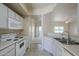 Clean and functional kitchen with white appliances, ample counter space, and access to the living area at 3236 E Chandler Blvd # 2003, Phoenix, AZ 85048