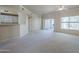 Bright living room with a ceiling fan, large window and sliding glass door to the outdoor patio at 3236 E Chandler Blvd # 2003, Phoenix, AZ 85048