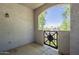 Cozy outdoor patio with a charming metal gate and views of the surrounding neighborhood at 3236 E Chandler Blvd # 2003, Phoenix, AZ 85048