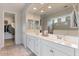 Bright primary bathroom featuring double sinks, granite countertops, and walk-in shower at 32567 N 133Rd Ave, Peoria, AZ 85383