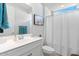 Clean bathroom with a white vanity, shower curtain, and modern fixtures at 32567 N 133Rd Ave, Peoria, AZ 85383