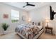 Cozy bedroom featuring a tiger themed bedding, a ceiling fan, and a bright window at 32567 N 133Rd Ave, Peoria, AZ 85383