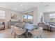 Bright dining area with a wooden table, upholstered chairs, and sliding doors leading to an outdoor space at 32567 N 133Rd Ave, Peoria, AZ 85383