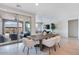 Dining area featuring a modern table, stylish chairs, sliding glass doors, and views of the outdoor patio at 32567 N 133Rd Ave, Peoria, AZ 85383