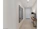 Hallway with sleek tile floors, mirrors, table, and white walls at 32567 N 133Rd Ave, Peoria, AZ 85383