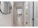 Hallway with neutral walls that provides access to the office and bathroom at 32567 N 133Rd Ave, Peoria, AZ 85383