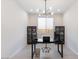Stylish home office boasts neutral tones, modern light fixture, and well-placed storage for a functional workspace at 32567 N 133Rd Ave, Peoria, AZ 85383
