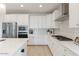 Modern kitchen with stainless steel appliances, quartz countertops, and sleek cabinetry offers style and functionality at 32567 N 133Rd Ave, Peoria, AZ 85383