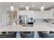 Bright kitchen featuring a large island with seating, stainless steel appliances, and modern pendant lighting at 32567 N 133Rd Ave, Peoria, AZ 85383