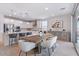 Open concept kitchen and dining area, featuring modern finishes, pendant lights, and stainless steel appliances at 32567 N 133Rd Ave, Peoria, AZ 85383